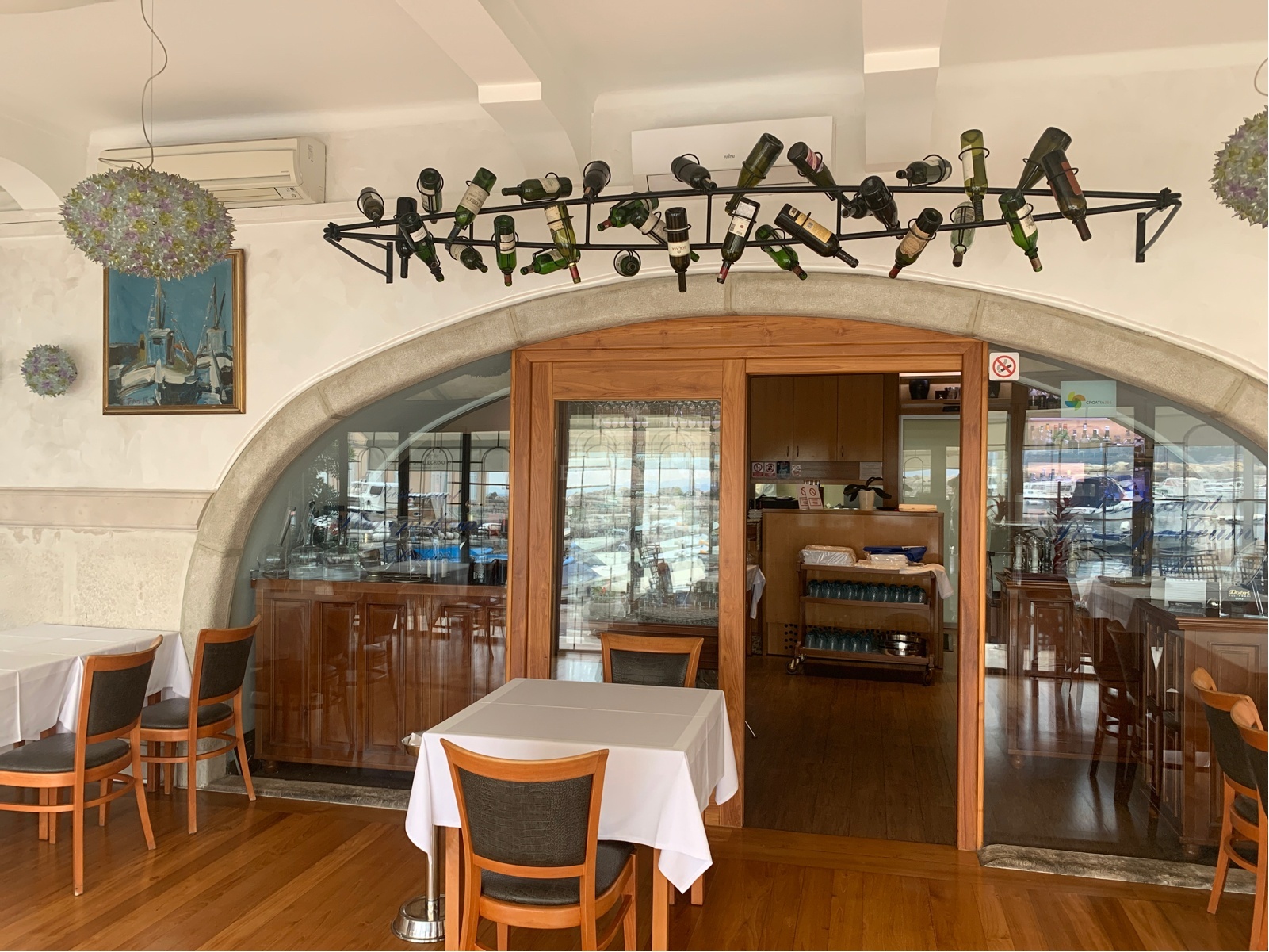 Interior view of Plavi Podrum restaurant with tables and sea views