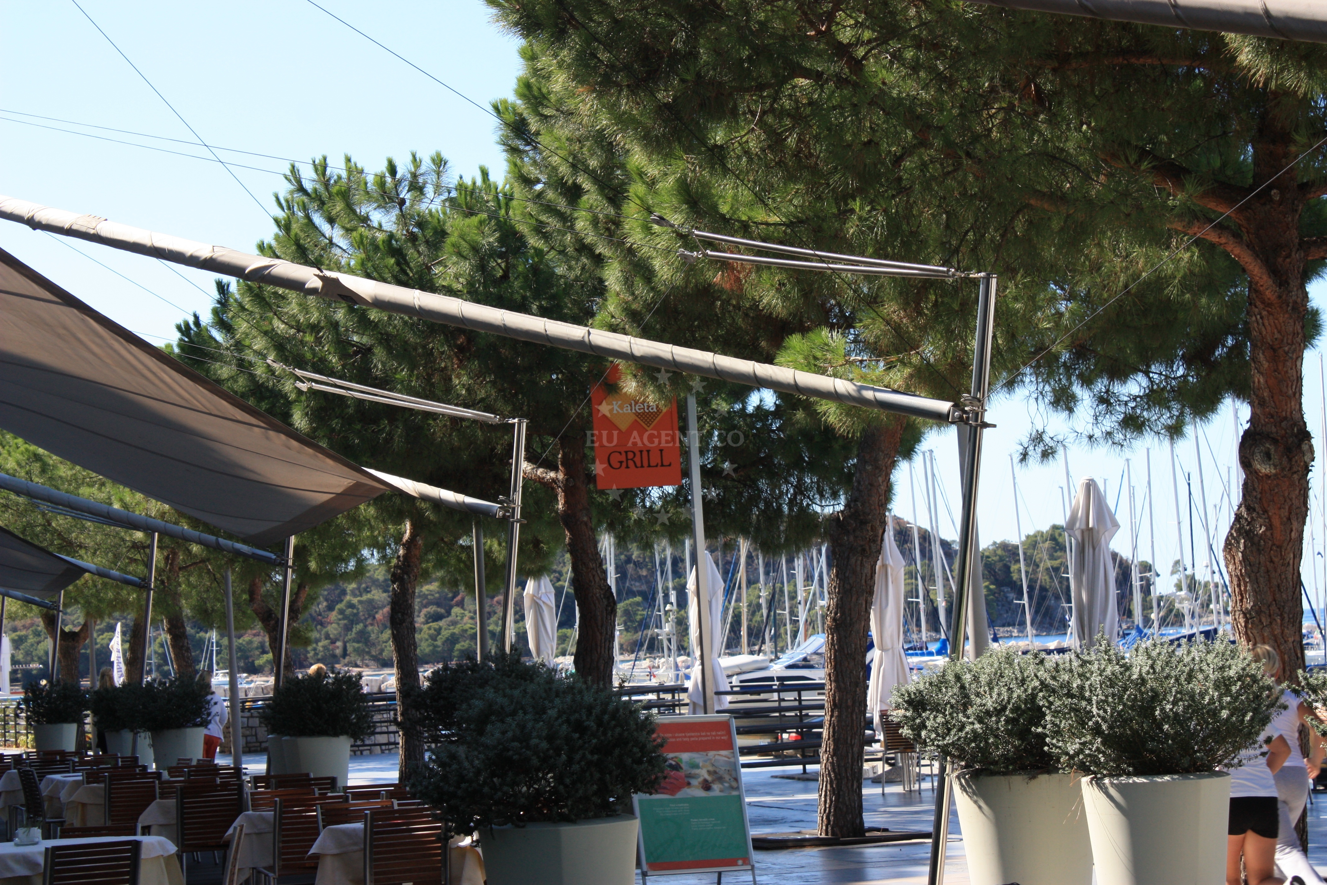 Dining area at Kaleta Restaurant, Rovinj, with views of the marina and nearby boats