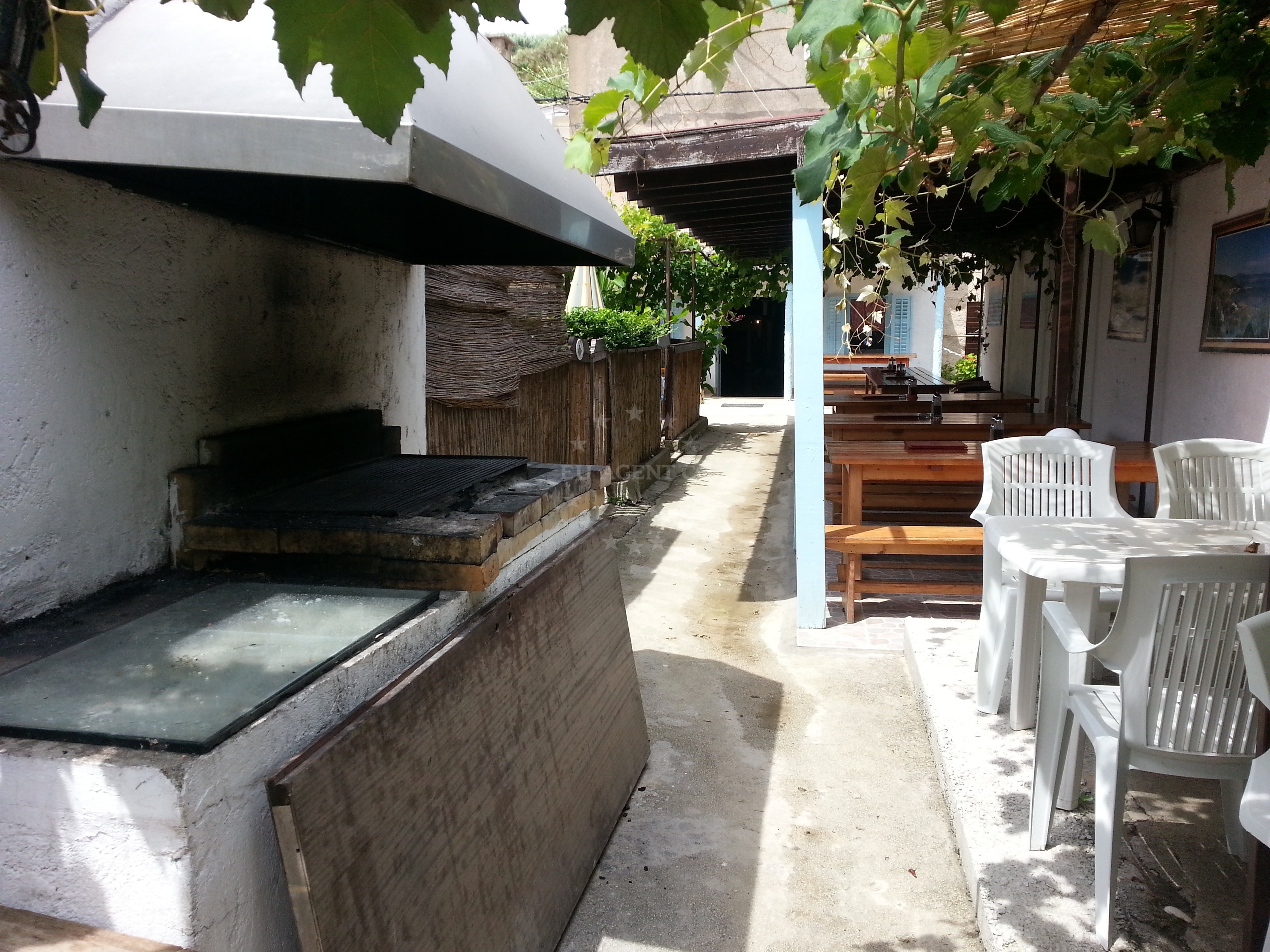 Outdoor seating area with tables along the alley