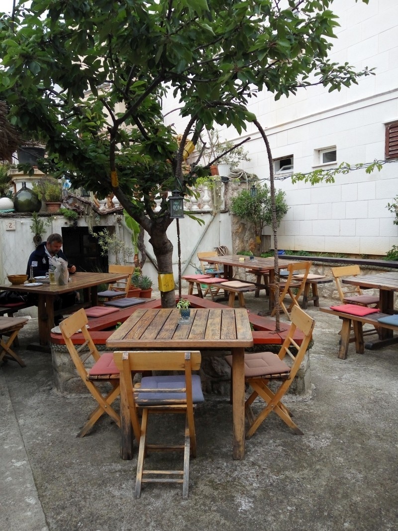 Dining area at Cotonum Restaurant with rustic wooden tables and views of Biograd na Moru