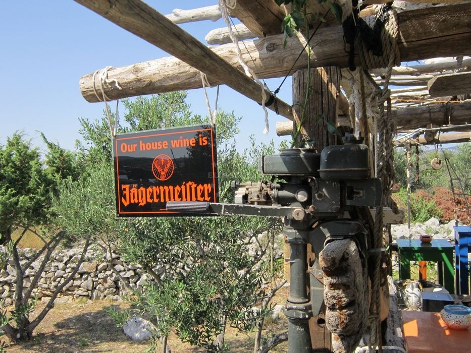 Local wine bottles displayed on a wooden shelf at La Spuz