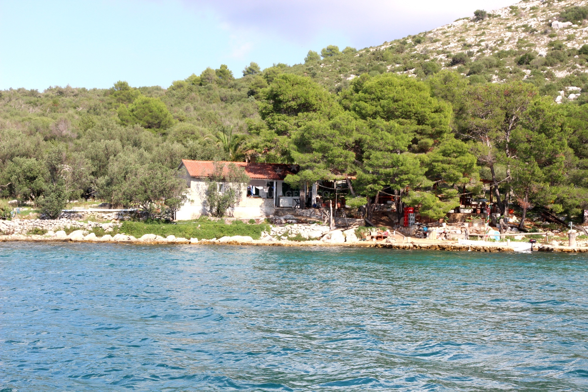Rustic dining area at Konoba Krsovica with views of the Adriatic Sea