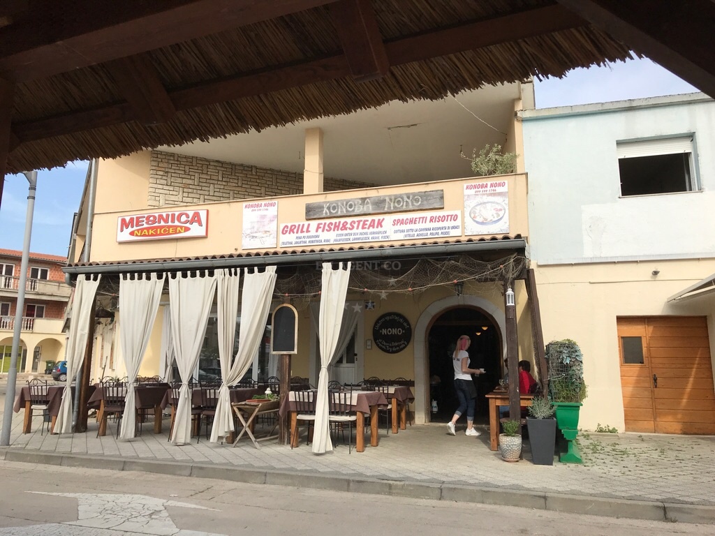 Konoba Nono restaurant in Pirovac, North Dalmatia, Croatia, overlooking the Adriatic Sea with a rustic wooden terrace.