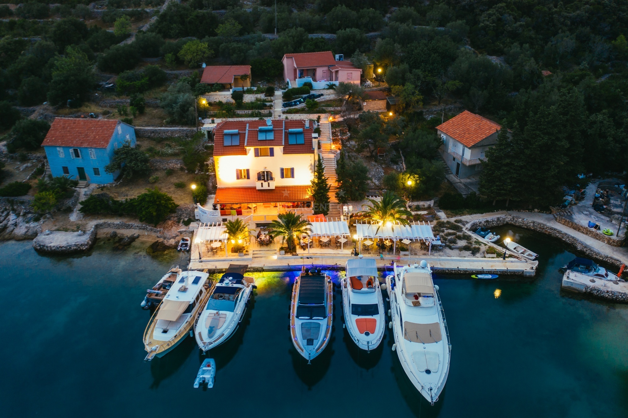 Villa Rava Restaurant quay with yachts moored in the bay, Rava Island, Croatia