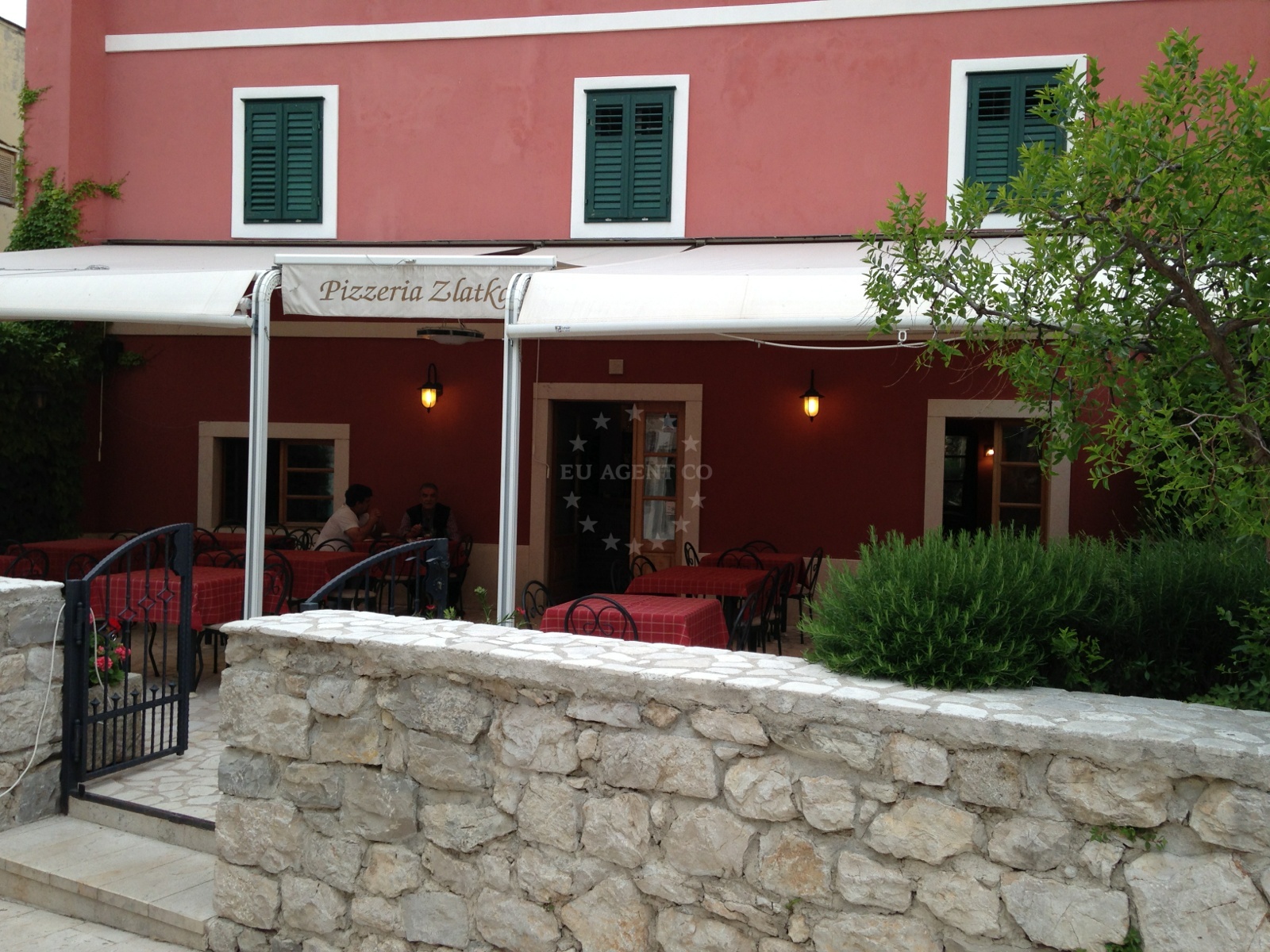 Pizzeria Zlatka in Skradin, North Dalmatia, Croatia, overlooking the marina with traditional Dalmatian architecture