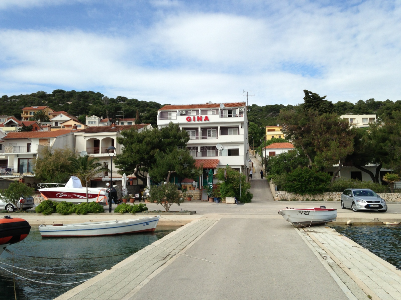 Gina Restaurant jetty with boats moored nearby, Tisno, Croatia