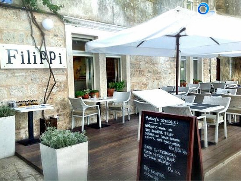 Restaurant Filippi on the Petar Kanavelić walkway in Korcula, Croatia, overlooking the Pelješac channel.