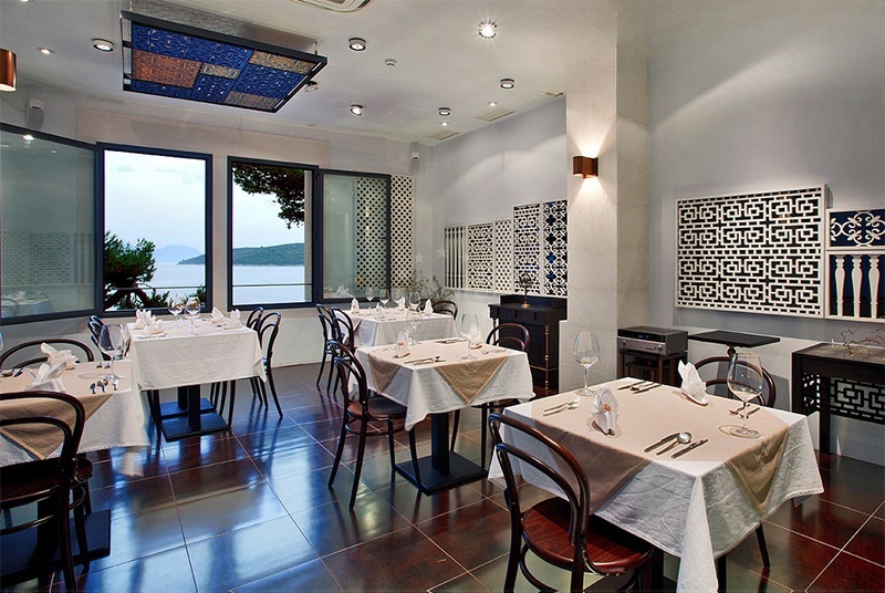 Interior of Restaurant Lesic Dimitri showcasing local art and maritime decor