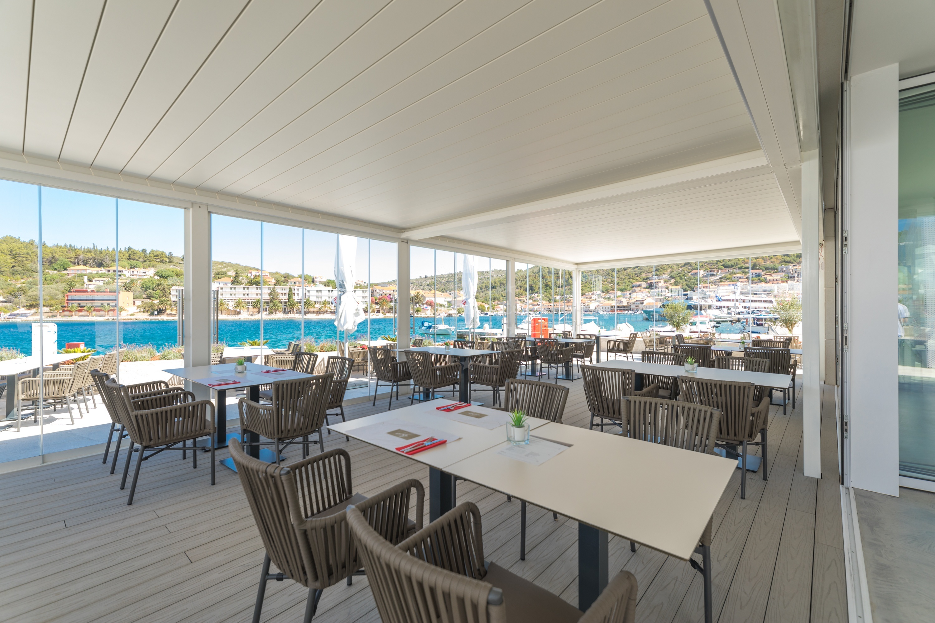 Dining area at Restaurant Luky with sunset backdrop