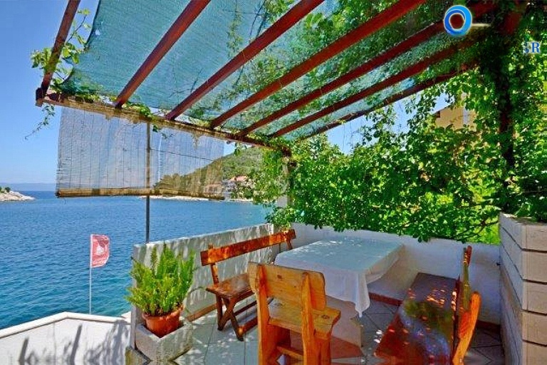 Dining area at Konoba Santor with views of Lastovo's coastline