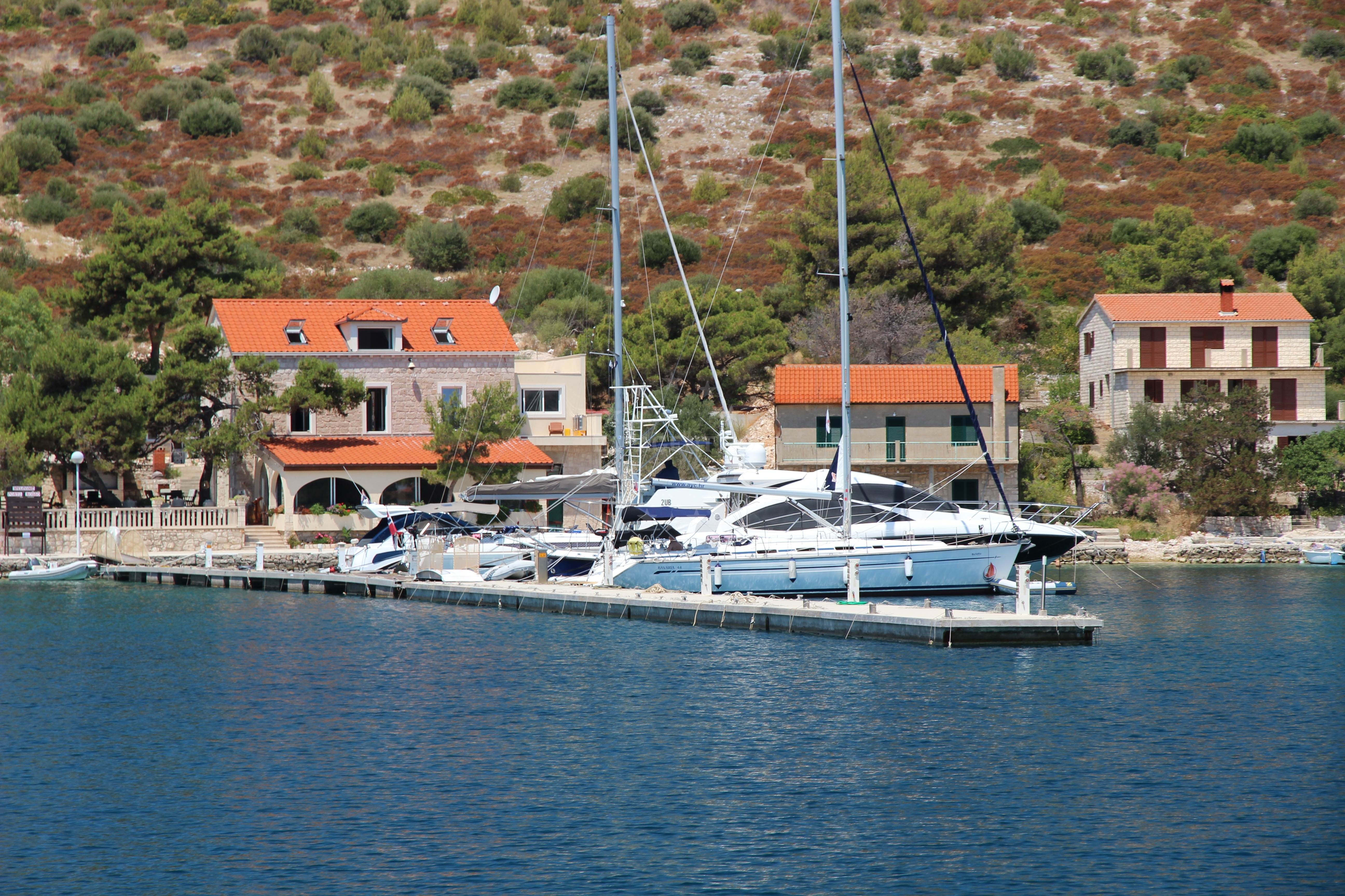 Restaurant Porto Rosso jetty with moored yachts in Skrivena Luka bay, Lastovo