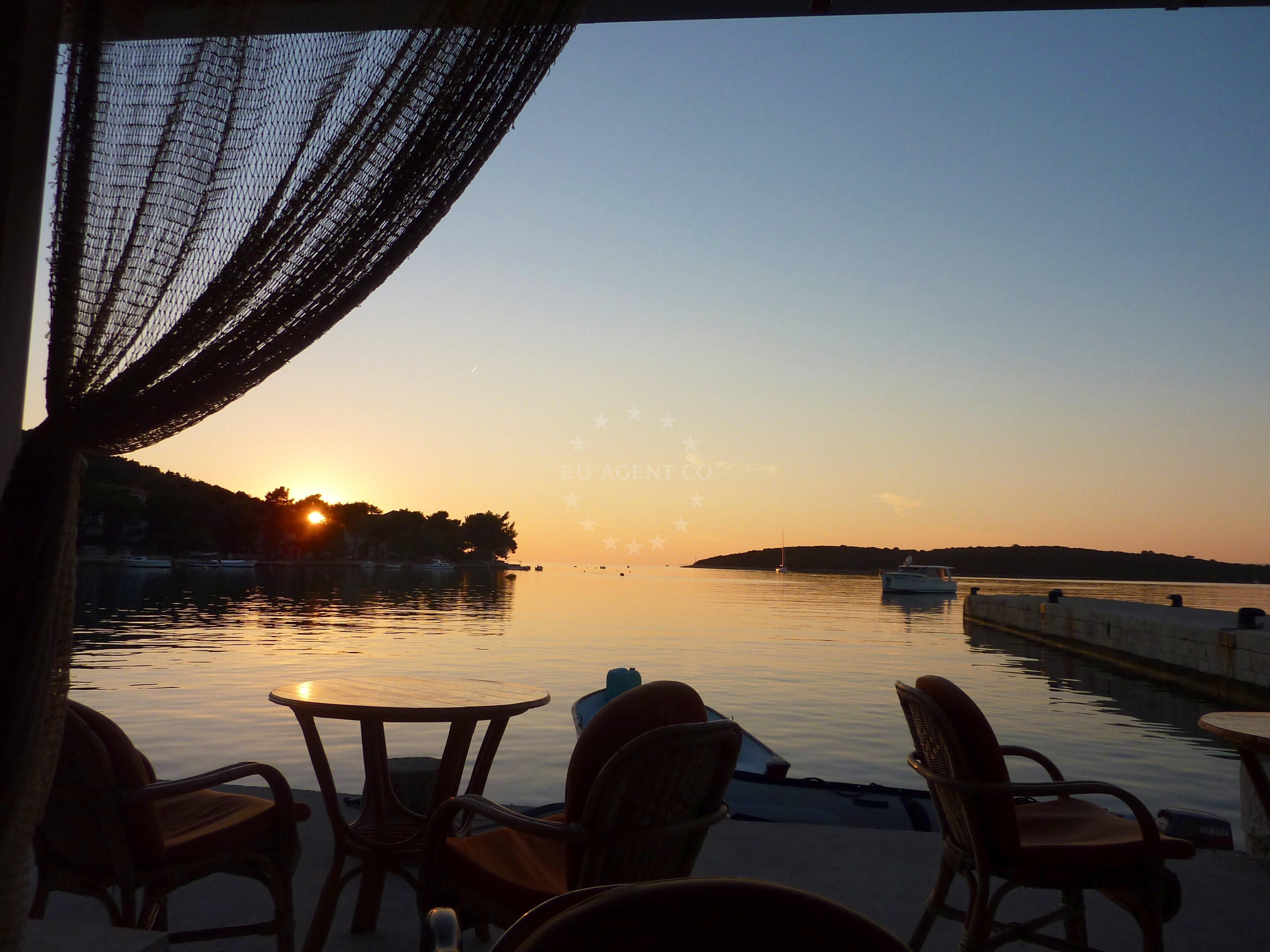 Restaurant in Lovište, South Dalmatia, overlooking the Adriatic Sea with a nearby jetty in the background.
