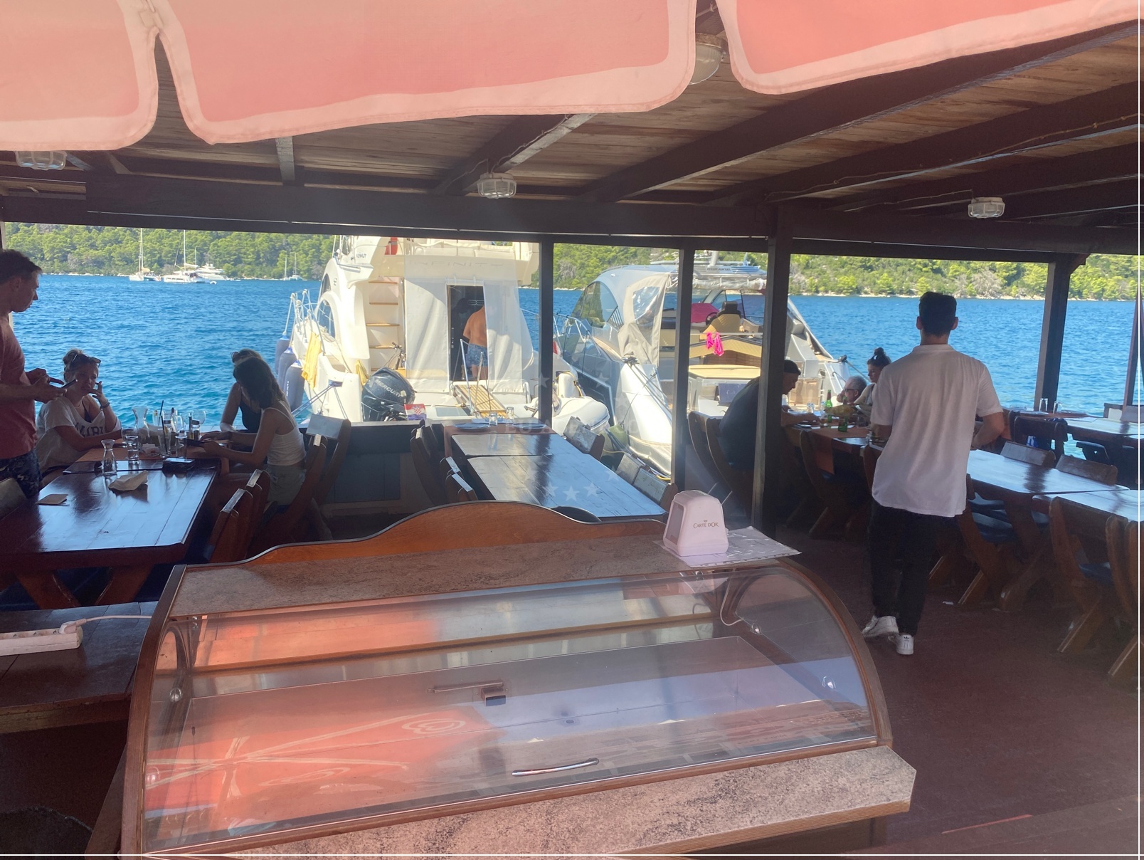 Dining area at Konoba Ogigija with harbor and quay visibility
