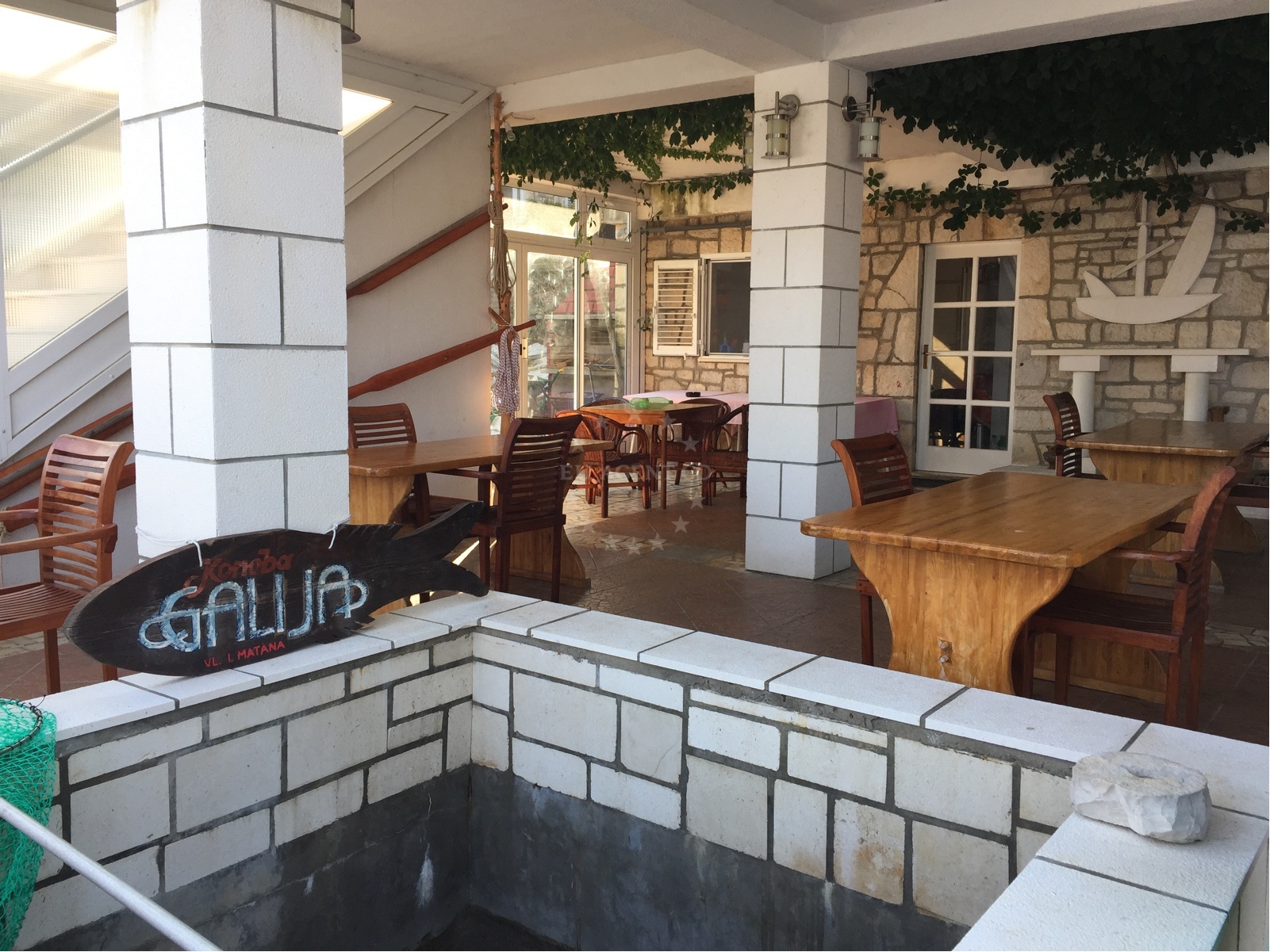 Dining area at Galija Restaurant with views of Pomena Harbor